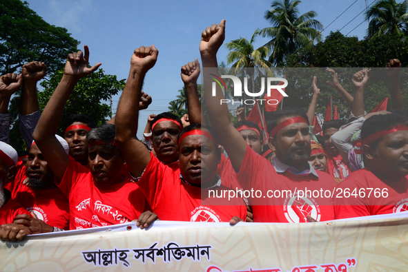 Bangladeshi garment workers and other labor organization members take part in a rally to mark May Day, International Workers' Day in Dhaka,...