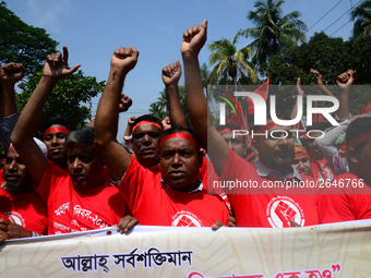 Bangladeshi garment workers and other labor organization members take part in a rally to mark May Day, International Workers' Day in Dhaka,...