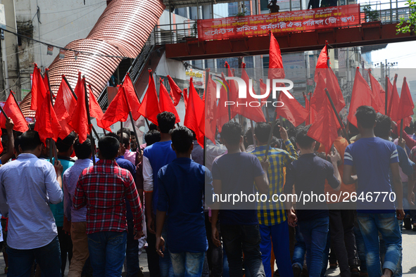 Bangladeshi garment workers and other labor organization members take part in a rally to mark May Day, International Workers' Day in Dhaka,...