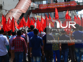 Bangladeshi garment workers and other labor organization members take part in a rally to mark May Day, International Workers' Day in Dhaka,...