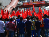 Bangladeshi garment workers and other labor organization members take part in a rally to mark May Day, International Workers' Day in Dhaka,...