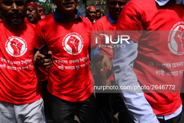 Bangladeshi garment workers and other labor organization members take part in a rally to mark May Day, International Workers' Day in Dhaka,...