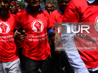 Bangladeshi garment workers and other labor organization members take part in a rally to mark May Day, International Workers' Day in Dhaka,...