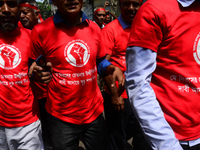 Bangladeshi garment workers and other labor organization members take part in a rally to mark May Day, International Workers' Day in Dhaka,...