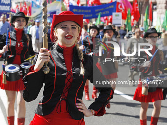 People hold red and green flags during a 1 May Day ( The International Labour Day) rally organised by the Ukrainian left-wing parties in Kie...