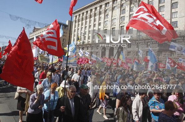 People hold red and green flags during a 1 May Day ( The International Labour Day) rally organised by the Ukrainian left-wing parties in Kie...