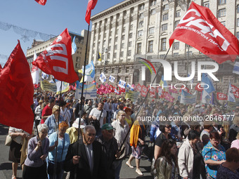 People hold red and green flags during a 1 May Day ( The International Labour Day) rally organised by the Ukrainian left-wing parties in Kie...