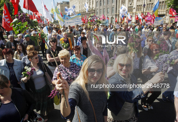 People hold red and green flags during a 1 May Day ( The International Labour Day) rally organised by the Ukrainian left-wing parties in Kie...