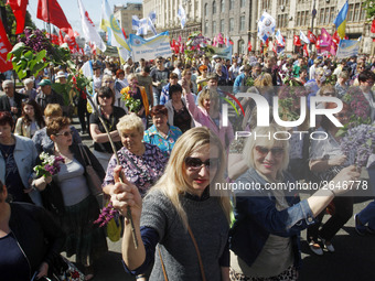 People hold red and green flags during a 1 May Day ( The International Labour Day) rally organised by the Ukrainian left-wing parties in Kie...