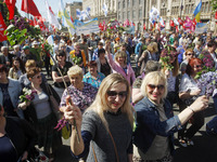 People hold red and green flags during a 1 May Day ( The International Labour Day) rally organised by the Ukrainian left-wing parties in Kie...