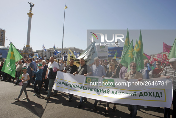 People hold red and green flags during a 1 May Day ( The International Labour Day) rally organised by the Ukrainian left-wing parties in Kie...