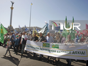 People hold red and green flags during a 1 May Day ( The International Labour Day) rally organised by the Ukrainian left-wing parties in Kie...