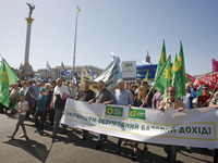 People hold red and green flags during a 1 May Day ( The International Labour Day) rally organised by the Ukrainian left-wing parties in Kie...