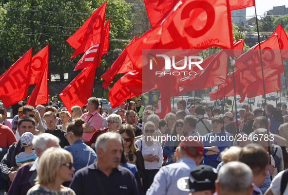 People hold red and green flags during a 1 May Day ( The International Labour Day) rally organised by the Ukrainian left-wing parties in Kie...