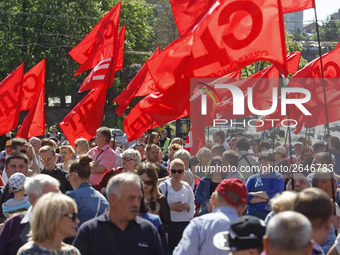 People hold red and green flags during a 1 May Day ( The International Labour Day) rally organised by the Ukrainian left-wing parties in Kie...