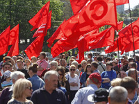 People hold red and green flags during a 1 May Day ( The International Labour Day) rally organised by the Ukrainian left-wing parties in Kie...