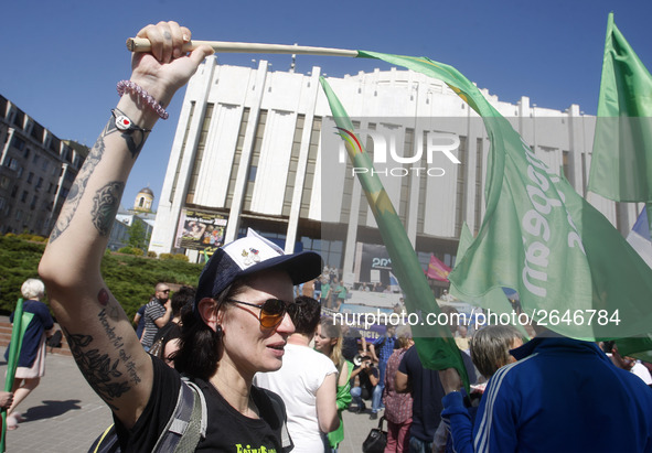 People hold red and green flags during a 1 May Day ( The International Labour Day) rally organised by the Ukrainian left-wing parties in Kie...