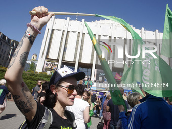 People hold red and green flags during a 1 May Day ( The International Labour Day) rally organised by the Ukrainian left-wing parties in Kie...