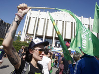 People hold red and green flags during a 1 May Day ( The International Labour Day) rally organised by the Ukrainian left-wing parties in Kie...