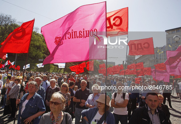 People hold red and green flags during a 1 May Day ( The International Labour Day) rally organised by the Ukrainian left-wing parties in Kie...