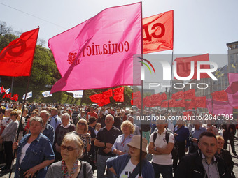 People hold red and green flags during a 1 May Day ( The International Labour Day) rally organised by the Ukrainian left-wing parties in Kie...