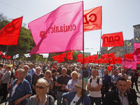 People hold red and green flags during a 1 May Day ( The International Labour Day) rally organised by the Ukrainian left-wing parties in Kie...