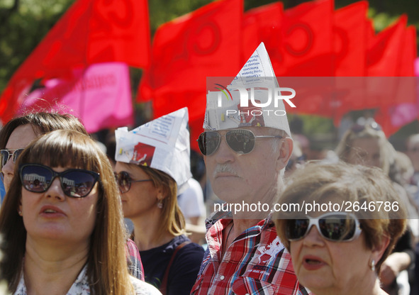 People hold red and green flags during a 1 May Day ( The International Labour Day) rally organised by the Ukrainian left-wing parties in Kie...