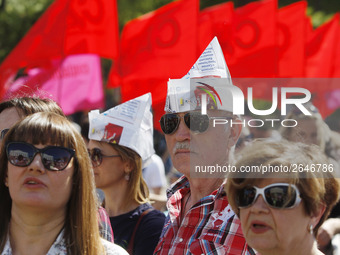 People hold red and green flags during a 1 May Day ( The International Labour Day) rally organised by the Ukrainian left-wing parties in Kie...