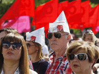 People hold red and green flags during a 1 May Day ( The International Labour Day) rally organised by the Ukrainian left-wing parties in Kie...