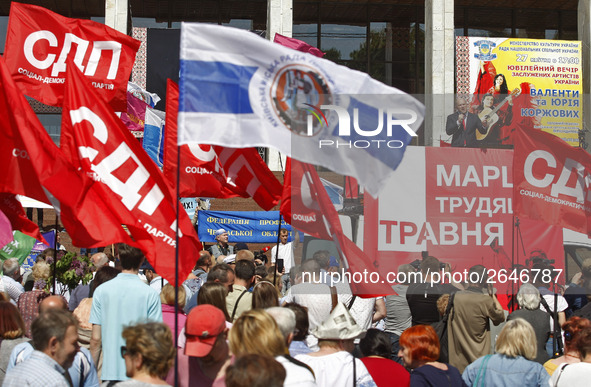 People hold red and green flags during a 1 May Day ( The International Labour Day) rally organised by the Ukrainian left-wing parties in Kie...