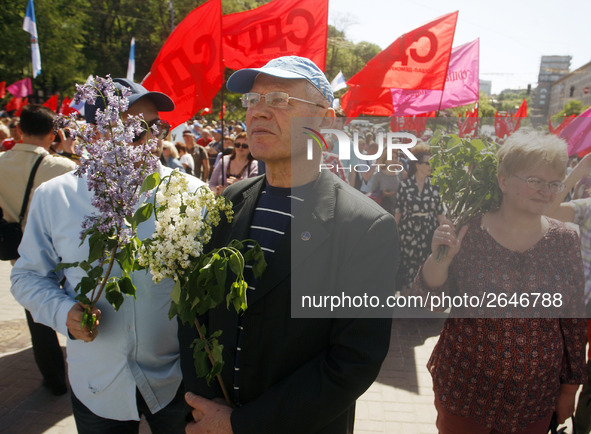 People hold red and green flags during a 1 May Day ( The International Labour Day) rally organised by the Ukrainian left-wing parties in Kie...