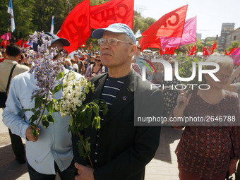 People hold red and green flags during a 1 May Day ( The International Labour Day) rally organised by the Ukrainian left-wing parties in Kie...