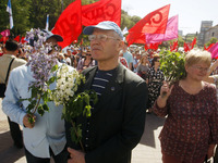 People hold red and green flags during a 1 May Day ( The International Labour Day) rally organised by the Ukrainian left-wing parties in Kie...