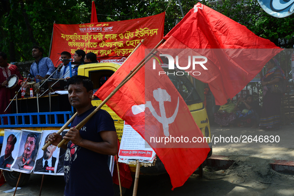 Bangladeshi garment workers and other labor organization members take part in a rally to mark May Day, International Workers' Day in Dhaka,...