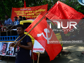 Bangladeshi garment workers and other labor organization members take part in a rally to mark May Day, International Workers' Day in Dhaka,...