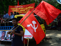 Bangladeshi garment workers and other labor organization members take part in a rally to mark May Day, International Workers' Day in Dhaka,...