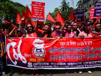 Bangladeshi garment workers and other labor organization members take part in a rally to mark May Day, International Workers' Day in Dhaka,...