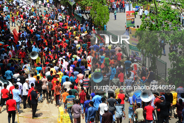 Bangladeshi garment workers and other labor organization members take part in a rally to mark May Day, International Workers' Day in Dhaka,...