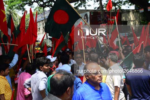 Bangladeshi garment workers and other labor organization members take part in a rally to mark May Day, International Workers' Day in Dhaka,...