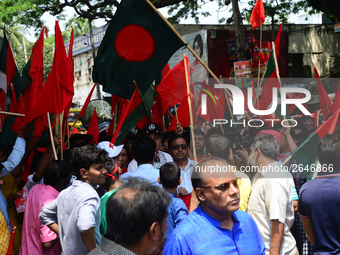 Bangladeshi garment workers and other labor organization members take part in a rally to mark May Day, International Workers' Day in Dhaka,...