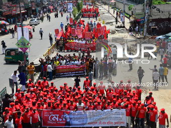 Bangladeshi garment workers and other labor organization members take part in a rally to mark May Day, International Workers' Day in Dhaka,...