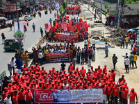 Bangladeshi garment workers and other labor organization members take part in a rally to mark May Day, International Workers' Day in Dhaka,...