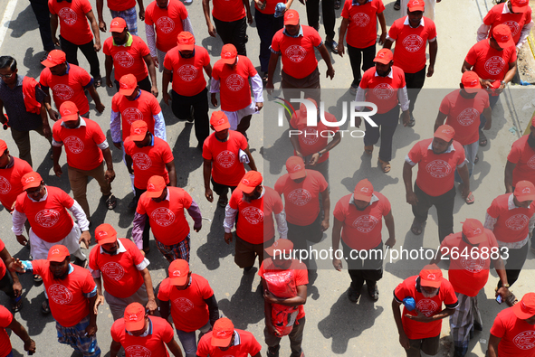 Bangladeshi garment workers and other labor organization members take part in a rally to mark May Day, International Workers' Day in Dhaka,...