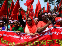 Bangladeshi garment workers and other labor organization members take part in a rally to mark May Day, International Workers' Day in Dhaka,...