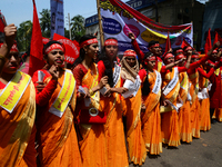 Bangladeshi garment workers and other labor organization members take part in a rally to mark May Day, International Workers' Day in Dhaka,...