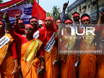 Bangladeshi garment workers and other labor organization members take part in a rally to mark May Day, International Workers' Day in Dhaka,...