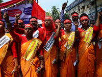 Bangladeshi garment workers and other labor organization members take part in a rally to mark May Day, International Workers' Day in Dhaka,...