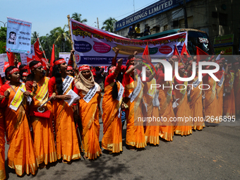 Bangladeshi garment workers and other labor organization members take part in a rally to mark May Day, International Workers' Day in Dhaka,...