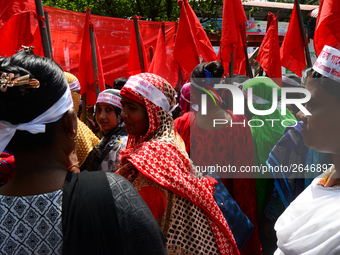 Bangladeshi garment workers and other labor organization members take part in a rally to mark May Day, International Workers' Day in Dhaka,...