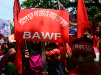 Bangladeshi garment workers and other labor organization members take part in a rally to mark May Day, International Workers' Day in Dhaka,...